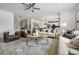 Open concept living room with hardwood floors, a fireplace, and comfortable seating at 344 Foxglove Way, Mcdonough, GA 30253