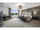 Main bedroom with a large bed, neutral color palette, and wood-look floors at 344 Foxglove Way, Mcdonough, GA 30253