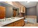 Modern bathroom featuring double vanity, exposed brick accent wall, and soaking tub at 350 Peters Sw St # 3, Atlanta, GA 30313