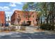 Exterior view of a three-story brick building with parking and mature trees at 350 Peters Sw St # 3, Atlanta, GA 30313