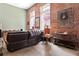 Comfortable living room featuring exposed brick walls, large windows, and stylish decor at 350 Peters Sw St # 3, Atlanta, GA 30313