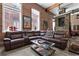 Spacious living room with exposed brick, large windows, stone fireplace, and leather sectional at 350 Peters Sw St # 3, Atlanta, GA 30313
