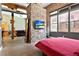 Bedroom with exposed brick, large windows, and a view into an open living space at 350 Peters Sw St # 3, Atlanta, GA 30313
