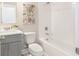 Clean bathroom with a tub, gray vanity, and updated fixtures at 3794 Jack Vernon Cir, Powder Springs, GA 30127