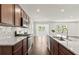 Modern kitchen with granite countertops and wood cabinets at 300 Foxglove Way, Mcdonough, GA 30253