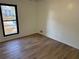 Small bedroom featuring a window and wood flooring at 296 Grist Mill Ln, Lawrenceville, GA 30046
