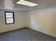 Carpeted room with a window and plain walls at 296 Grist Mill Ln, Lawrenceville, GA 30046
