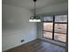 Dining room featuring wood flooring, chandelier and a large window at 296 Grist Mill Ln, Lawrenceville, GA 30046