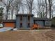 Charming blue two-story home with an attached garage and freshly painted orange trim at 296 Grist Mill Ln, Lawrenceville, GA 30046