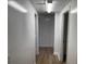 Hallway with white walls, ceiling tiles and wood flooring at 296 Grist Mill Ln, Lawrenceville, GA 30046