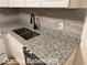 Close-up on a kitchen countertop with a double sink and black faucet at 296 Grist Mill Ln, Lawrenceville, GA 30046