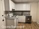 A kitchen with white cabinets, gray countertops, and stainless steel appliances at 296 Grist Mill Ln, Lawrenceville, GA 30046