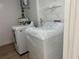 A compact laundry room with a washer and dryer at 296 Grist Mill Ln, Lawrenceville, GA 30046