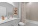 Clean bathroom with shower/tub combo, white vanity, and neutral tile at 440 Dahlia St, Mcdonough, GA 30253