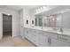 Bathroom featuring double vanity with a large mirror and tiled floors at 440 Dahlia St, Mcdonough, GA 30253