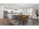 Modern kitchen with island, stainless steel appliances, and dining area at 440 Dahlia St, Mcdonough, GA 30253
