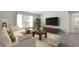 Cozy living room with plush seating, a large window, and a mounted television at 440 Dahlia St, Mcdonough, GA 30253