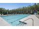 Resort-style pool featuring crystal clear water, deck chairs, and lush surrounding greenery at 440 Dahlia St, Mcdonough, GA 30253