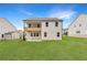 Large, level backyard with a covered patio and deck, offering ample space for relaxation and outdoor activities at 715 Crossroad Ct, Powder Springs, GA 30127