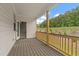 Cozy balcony with wood railing and flooring offering views of a landscaped yard and wooded area at 715 Crossroad Ct, Powder Springs, GA 30127