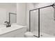 Modern bathroom with a glass shower, marble tile, black accents and a white countertop sink at 715 Crossroad Ct, Powder Springs, GA 30127