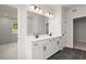 Elegant bathroom with dual sinks, modern vanity, and stylish tile flooring, offering a luxurious feel at 715 Crossroad Ct, Powder Springs, GA 30127