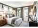 Light-filled bedroom with a comfortable bed and large windows at 715 Crossroad Ct, Powder Springs, GA 30127