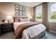 Cozy bedroom with gray upholstered bed, mauve blanket, and dark wood nightstands at 715 Crossroad Ct, Powder Springs, GA 30127