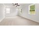 Spacious bedroom with carpet, windows, and a ceiling fan at 715 Crossroad Ct, Powder Springs, GA 30127