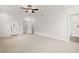 Bright bedroom featuring a ceiling fan, carpet flooring, and access to both a balcony and an ensuite bathroom at 715 Crossroad Ct, Powder Springs, GA 30127