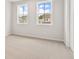 Neutral bedroom with carpet flooring, windows, and a nearby door at 715 Crossroad Ct, Powder Springs, GA 30127