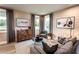 Spacious bonus room with plenty of natural light and comfortable furniture at 715 Crossroad Ct, Powder Springs, GA 30127