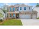 Two-story home with stone accents and a three-car garage at 715 Crossroad Ct, Powder Springs, GA 30127