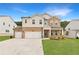 Beautiful two-story home with a stone and siding exterior, three-car garage, and a well-manicured lawn at 715 Crossroad Ct, Powder Springs, GA 30127