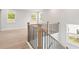 Hallway with wood floors, staircase with black iron spindles, and natural light at 715 Crossroad Ct, Powder Springs, GA 30127
