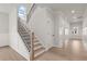 View of the staircase, hallway and entry way with white trim, recessed lighting and hardwood floors at 715 Crossroad Ct, Powder Springs, GA 30127