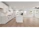 Spacious kitchen featuring white cabinets, quartz countertops, an island, and stainless steel appliances at 715 Crossroad Ct, Powder Springs, GA 30127