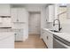 Modern kitchen with white cabinets, marble countertops, stainless steel appliances and hardwood floors at 715 Crossroad Ct, Powder Springs, GA 30127