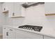 Modern kitchen featuring marble countertops, white cabinets, and stainless steel gas range at 715 Crossroad Ct, Powder Springs, GA 30127