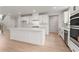 Modern kitchen with a large island, white cabinets, stainless steel appliances, and an open layout at 715 Crossroad Ct, Powder Springs, GA 30127