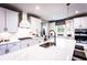 White kitchen with marble countertops and a large island at 715 Crossroad Ct, Powder Springs, GA 30127