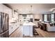 Open concept kitchen with island, white cabinets, and stainless steel appliances at 715 Crossroad Ct, Powder Springs, GA 30127