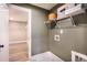 Convenient laundry room with shelving and access to a closet at 715 Crossroad Ct, Powder Springs, GA 30127