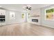 Bright living room with a modern fireplace, large windows, and a view of the backyard and kitchen at 715 Crossroad Ct, Powder Springs, GA 30127