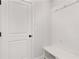 Bright mudroom with built-in bench, coat hooks, and white door at 715 Crossroad Ct, Powder Springs, GA 30127