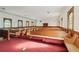 Sanctuary with wooden pews and red carpet at 193 Gibson St, Atlanta, GA 30316