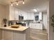 Bright kitchen features white cabinets, granite countertops, stainless appliances, and wood-look floors at 2068 Verbena Nw St, Atlanta, GA 30314