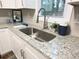 Modern kitchen with white cabinets and a stainless steel sink at 2068 Verbena Nw St, Atlanta, GA 30314