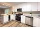 Modern kitchen with white cabinets, granite counters, and stainless steel appliances at 2068 Verbena Nw St, Atlanta, GA 30314