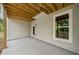 Spacious back porch with an exposed beam ceiling and backyard access at 220 Autumn Brook Dr, Canton, GA 30115